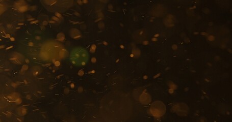Abstract particles of gold dust float in the air