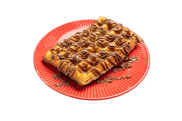 Waffle with chocolate syrup on red plate breakfast