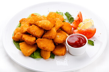 Crispy golden chicken nuggets served with ketchup and a garnish