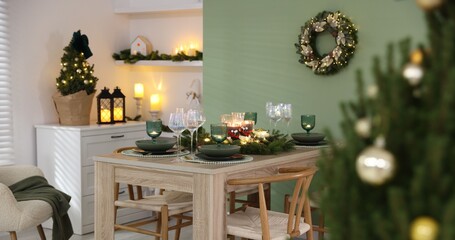 Festive table setting with Christmas decor indoors