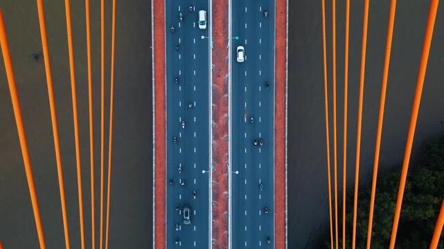 Symmetric modern cable-stayed bridge over Han river in Da Nang, Contemporary urban span connecting city across waterway 4k, aerial drone view, directly above perspective