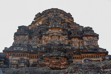 Fototapeta premium Graceful stone carvings on towers of an ancient Indian temple. Hampi