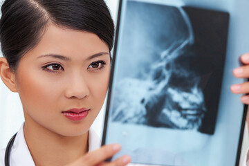 Chinese Female Woman Hospital Doctor Looking at Skull X-Ray