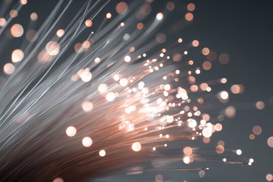 Glowing fiber-optic connector with sparkling strands against soft background