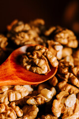 Peeled walnuts in a wooden bowl, ready for snacking or baking, captured in warm lighting