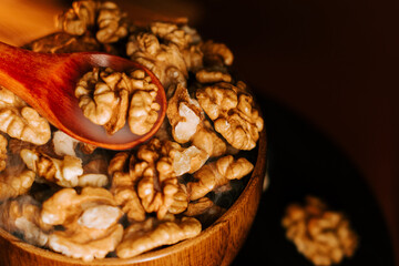 Peeled walnuts in a wooden bowl ready for cooking or snacking in a cozy kitchen setting
