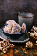 Traditional christmas cookies in a bowl on a rustic wooden background. Soft focus.	