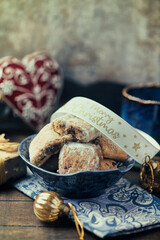 Traditional christmas cookies in a bowl on a rustic wooden background. Soft focus.	