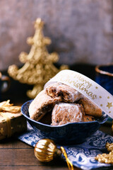 Traditional christmas cookies in a bowl on a rustic wooden background. Soft focus.	