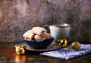 Traditional christmas cookies in a bowl on a rustic wooden background. Soft focus.	