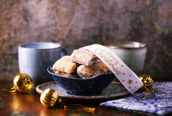 Traditional christmas cookies in a bowl on a rustic wooden background. Soft focus.	