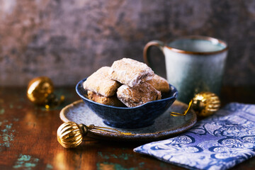 Traditional christmas cookies in a bowl on a rustic wooden background. Soft focus.	