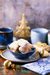 Traditional christmas cookies in a bowl on a rustic wooden background. Soft focus.	