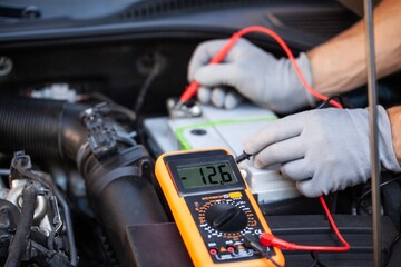 Hands car mechanic repair service checks electrical circuits