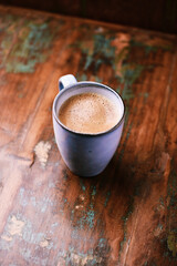 Cup of coffee on rustic wooden background. Soft focus. Copy space	