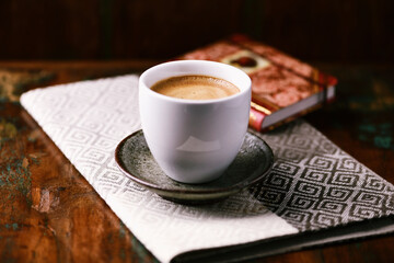 Cup of coffee on rustic wooden background. Soft focus. Copy space	