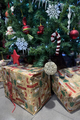 green christmas tree decorated with christmas decorations and gift boxes