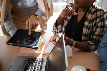 Business women collaborating using digital tablet and laptop