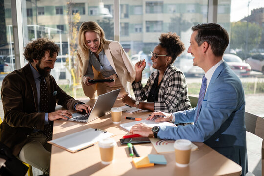 Diverse business professionals collaborating cheerfully at a meeting