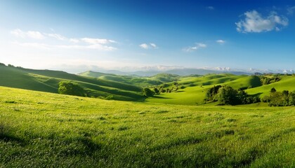 Obraz premium a picturesque scene captures expansive rolling hills and lush fields under a clear blue sky in the countryside