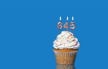 Birthday Or Anniversary Cupcake With Lit Candles; Candles Forming The Number 645