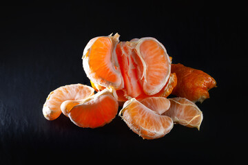 Tangerine slices. Tangerine on a dark