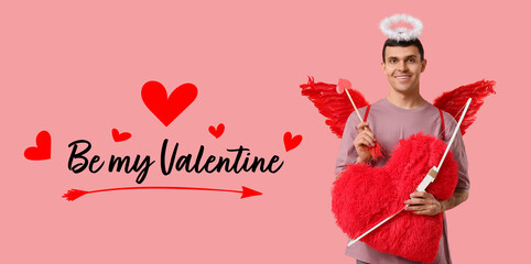 Obraz premium Young man dressed as Cupid with bow and heart pillow on pink background. Valentine's Day celebration