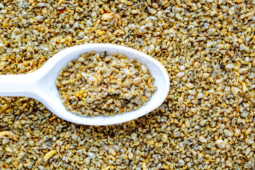 Aquarium fish fodder closeup.Dry food for aquarium fish on  spoon Daphnia.Aquarium.Top view