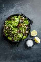 Fresh leaves salad plate. Healthy food. Diet dinner or lunch menu. Salad plate on table. Flat lay. View from above