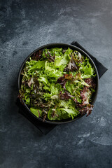 Fresh leaves salad plate. Healthy food. Diet dinner or lunch menu. Salad plate on table. Flat lay. View from above