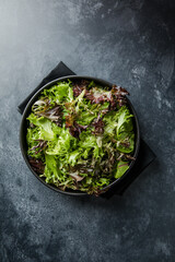 Fresh leaves salad plate. Healthy food. Diet dinner or lunch menu. Salad plate on table. Flat lay. View from above