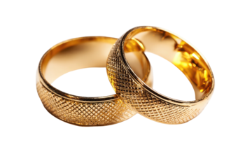 Gold wedding rings, textured surface, isolated on a black background