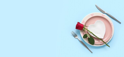 Simple table setting for Valentine's Day on blue background with space for text
