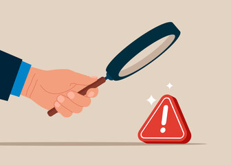 Hand with magnifying glass and investigate incident with exclamation attention sign. Incident management, root cause analysis or solving problem, identify risk or critical failure.