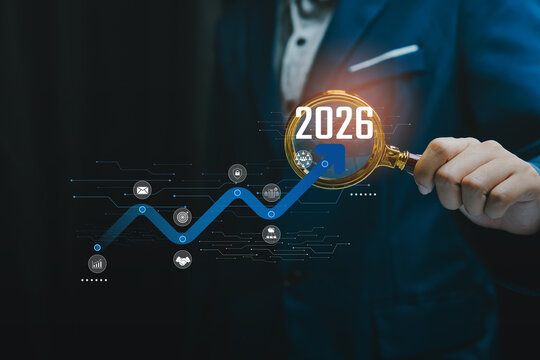 Hand holding magnifier over rising trend to 2026, future planning forecasting ambition growth strategy opportunity analysis confidence, business outlook concept