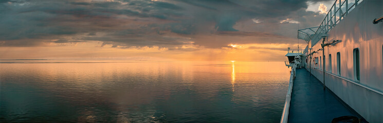 Ship sailing on Baltic Sea during golden sunset