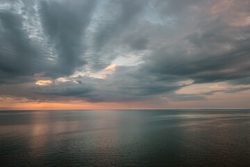 Baltic Sea horizon at sunset with dark clouds