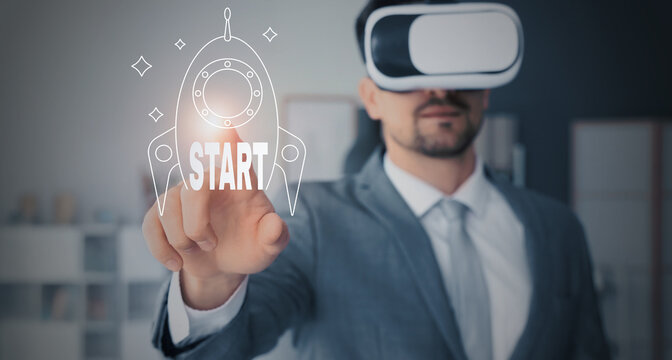 Young businessman in VR glasses using virtual screen at office, closeup - Powered by Adobe