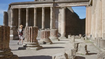 Pompeii ruins in shallow bokeh with defocused ancient stone columns and crumbling masonry in an outdoor plaza; background backplate copyspace template. - Powered by Adobe