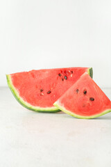 Pieces of ripe watermelon on light background
