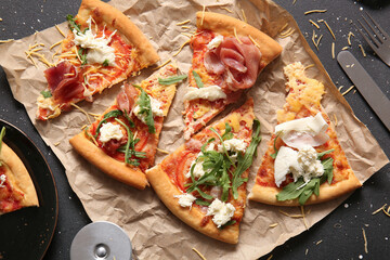 Slices of tasty pizza with Burrata cheese on black background