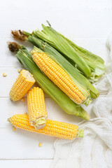 Fresh corn cobs on white table