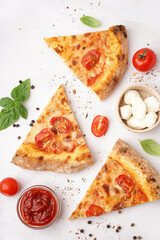 Naklejka premium Pieces of tasty pizza Margarita with basil and bowl of mozzarella on white background