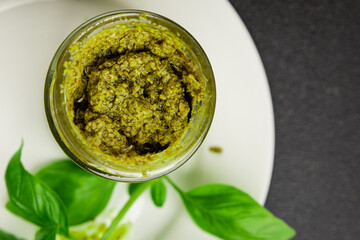 Pesto sauce basil, olive oil, parmesan, pine nuts, garlic natural product tasty snack fresh delicious gourmet food background on the table rustic top view copy space