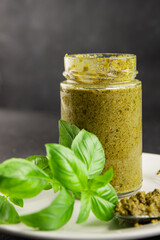 Pesto sauce basil, olive oil, parmesan, pine nuts, garlic natural product tasty snack fresh delicious gourmet food background on the table rustic top view copy space