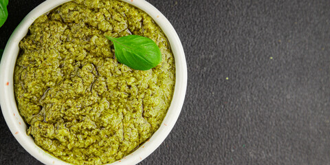Pesto sauce basil, olive oil, parmesan, pine nuts, garlic natural product tasty snack fresh delicious gourmet food background on the table rustic top view copy space