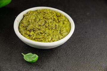 Pesto sauce basil, olive oil, parmesan, pine nuts, garlic natural product tasty snack fresh delicious gourmet food background on the table rustic top view copy space
