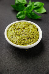 Pesto sauce basil, olive oil, parmesan, pine nuts, garlic natural product tasty snack fresh delicious gourmet food background on the table rustic top view copy space