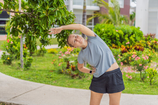 Unaltered woman exercising in a park, enjoying movement, fresh air and a healthy outdoor routine. Concept of fitness, wellbeing, positive lifestyle, energy, self-care and everyday outdoor activity in