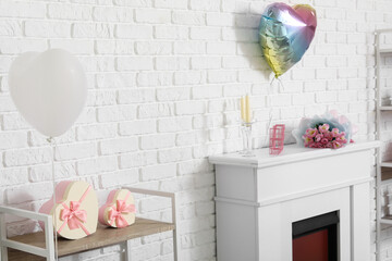 Fototapeta premium Interior of modern living room with fireplace and decorations for Valentine's Day celebration
